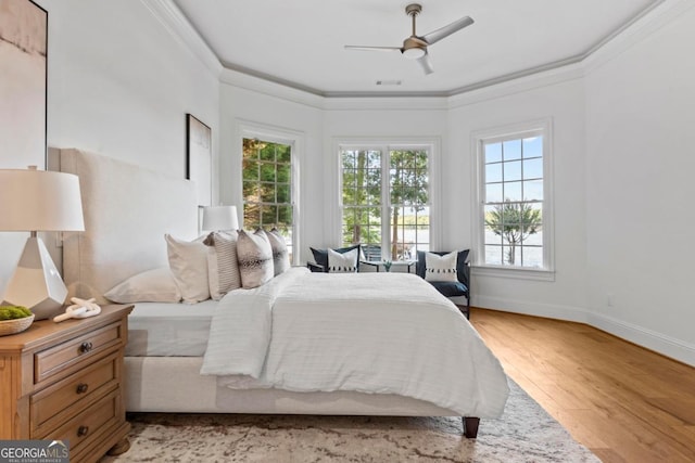1230 Lake Club Dr, Greensboro, GA 30642 - bedroom featuring multiple windows, light wood-style floors, ornamental molding, and ceiling fan