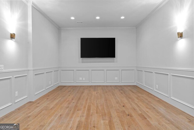 1230 Lake Club Dr, Greensboro, GA 30642 - empty room featuring ornamental molding, hardwood / wood-style flooring, a decorative wall, and wainscoting