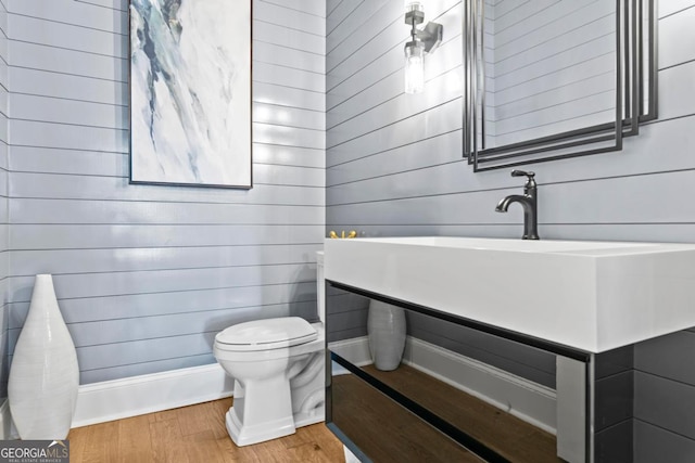 1230 Lake Club Dr, Greensboro, GA 30642 - bathroom with wood finished floors, wood walls, and vanity