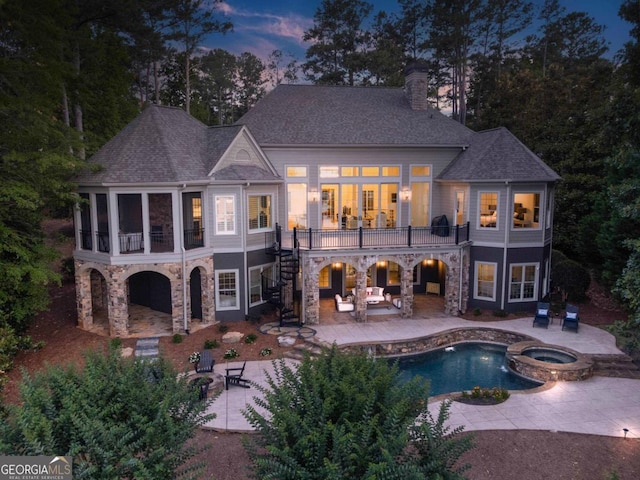 1230 Lake Club Dr, Greensboro, GA 30642 - rear view of house with stairway, a patio, a chimney, a sunroom, and stone siding
