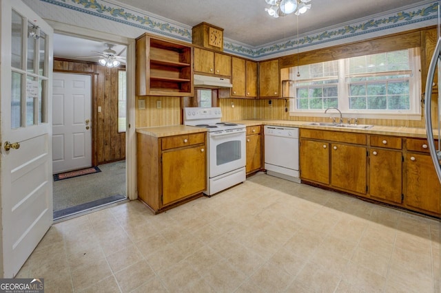 6111 Old Monticello St SE, Covington, GA 30014 - kitchen with white appliances, under cabinet range hood, brown cabinets, light countertops, and ornamental molding