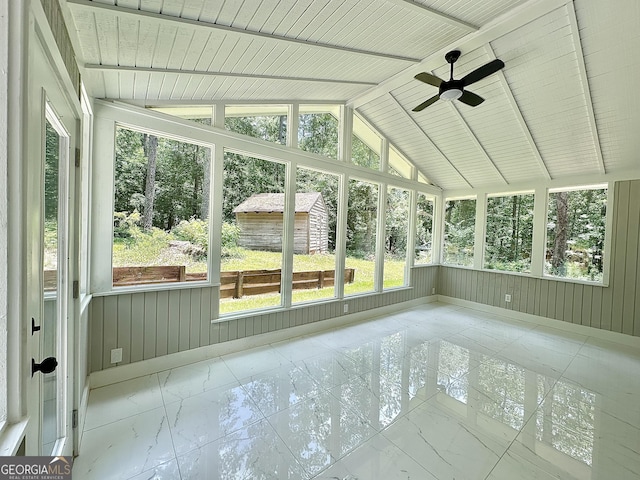 115 Creekside Ln, Covington, GA 30016 - unfurnished sunroom with marble look tile flooring, ceiling fan, lofted ceiling, and healthy amount of natural light