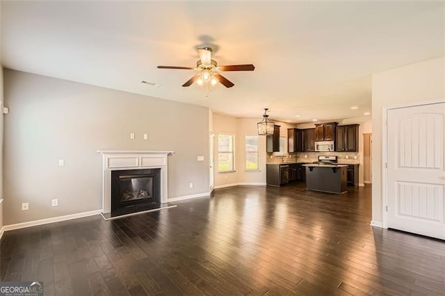 219 Sleepy Way, Canton, GA 30114 - unfurnished living room with a ceiling fan, dark wood finished floors, a glass covered fireplace, and recessed lighting