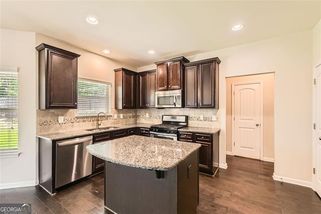 219 Sleepy Way, Canton, GA 30114 - kitchen featuring stainless steel appliances, dark brown cabinets, tasteful backsplash, plenty of natural light, and recessed lighting