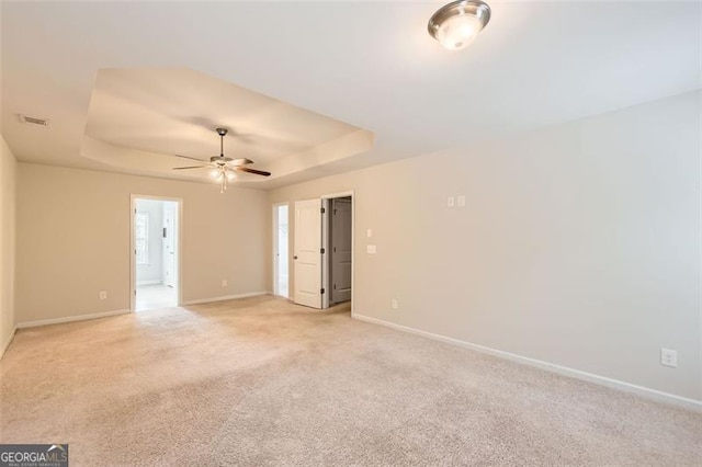 219 Sleepy Way, Canton, GA 30114 - spare room with a raised ceiling, a ceiling fan, and light colored carpet