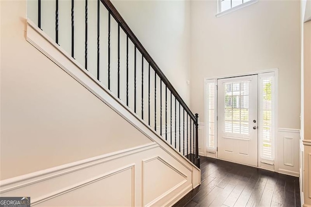 219 Sleepy Way, Canton, GA 30114 - entryway featuring stairs, dark wood-type flooring, a high ceiling, a wainscoted wall, and a decorative wall