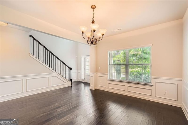 219 Sleepy Way, Canton, GA 30114 - spare room featuring a chandelier, a wainscoted wall, stairway, dark wood-style flooring, and a decorative wall