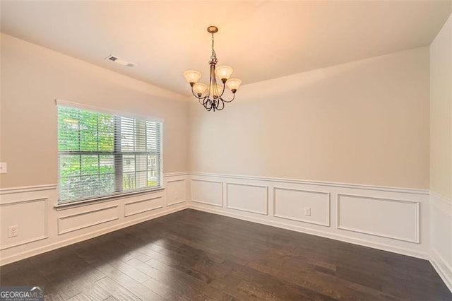 219 Sleepy Way, Canton, GA 30114 - empty room featuring a chandelier, dark wood-style flooring, a wainscoted wall, and a decorative wall