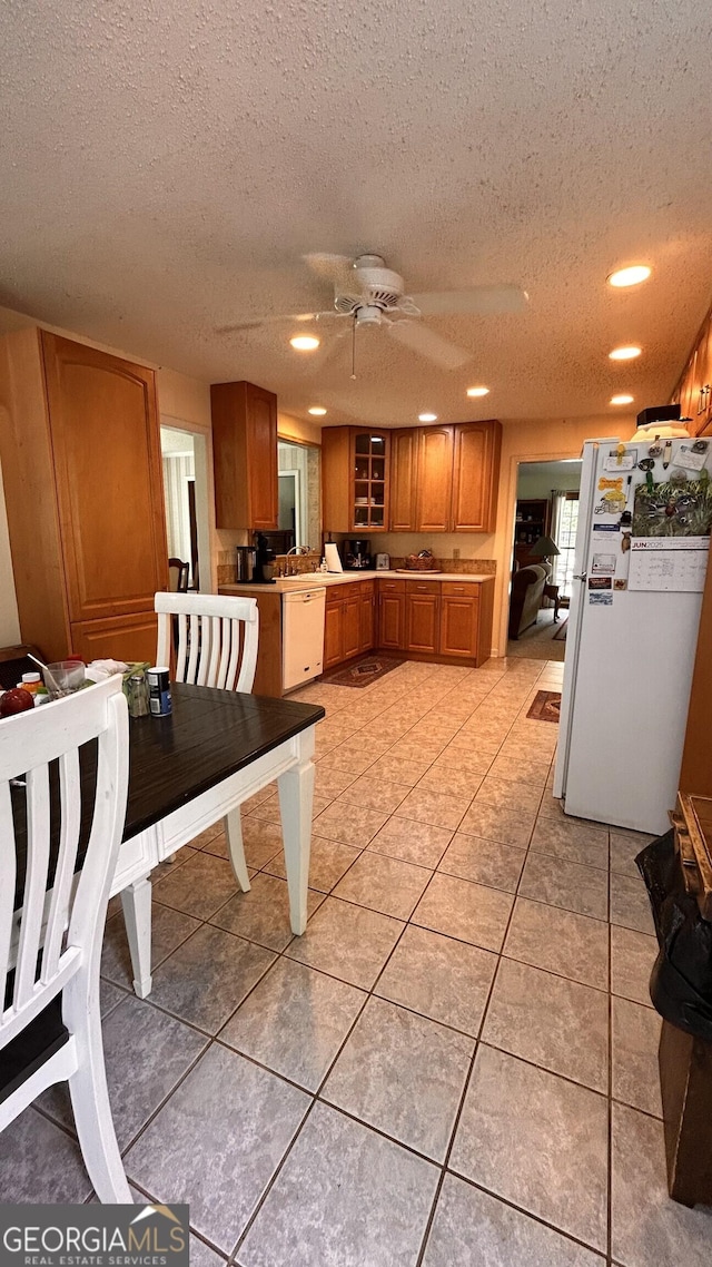 5904 Clairmont Way, Powder Springs, GA 30127 - kitchen featuring white appliances, a textured ceiling, brown cabinetry, recessed lighting, and ceiling fan
