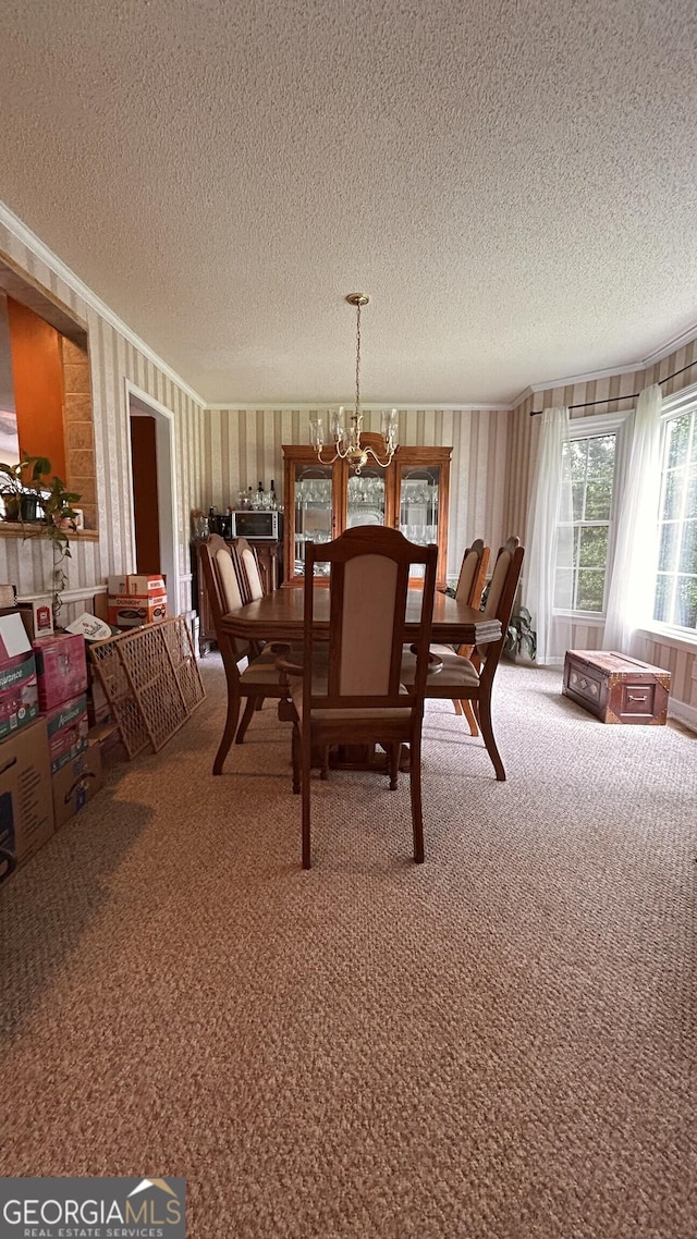 5904 Clairmont Way, Powder Springs, GA 30127 - carpeted dining room featuring a textured ceiling, ornamental molding, and a chandelier