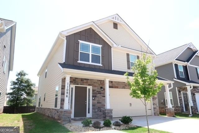 11096 Cornerstone Way, Hampton, GA 30228 - craftsman inspired home with board and batten siding, concrete driveway, stone siding, and a garage