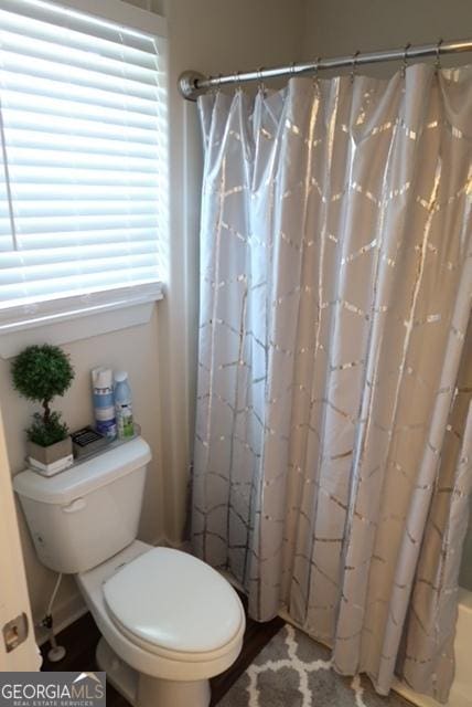 11096 Cornerstone Way, Hampton, GA 30228 - bathroom with toilet and a shower with shower curtain