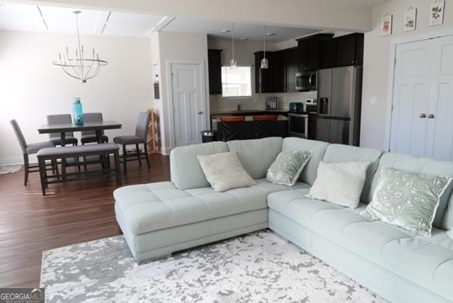 11096 Cornerstone Way, Hampton, GA 30228 - living room featuring wood finished floors and a chandelier