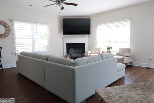 11096 Cornerstone Way, Hampton, GA 30228 - living area featuring ceiling fan, a fireplace, and dark wood-style floors
