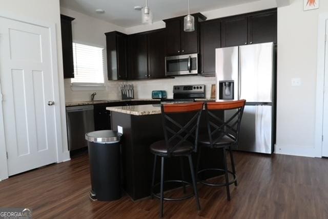 11096 Cornerstone Way, Hampton, GA 30228 - kitchen with stainless steel appliances, a kitchen island, dark wood-type flooring, a kitchen bar, and dark cabinetry