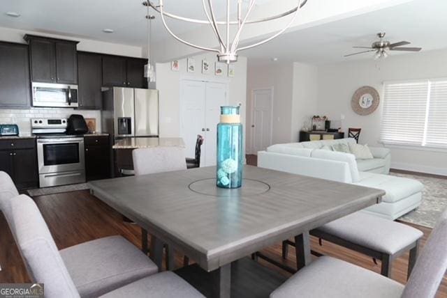 11096 Cornerstone Way, Hampton, GA 30228 - dining space with wood finished floors, ceiling fan, and a chandelier