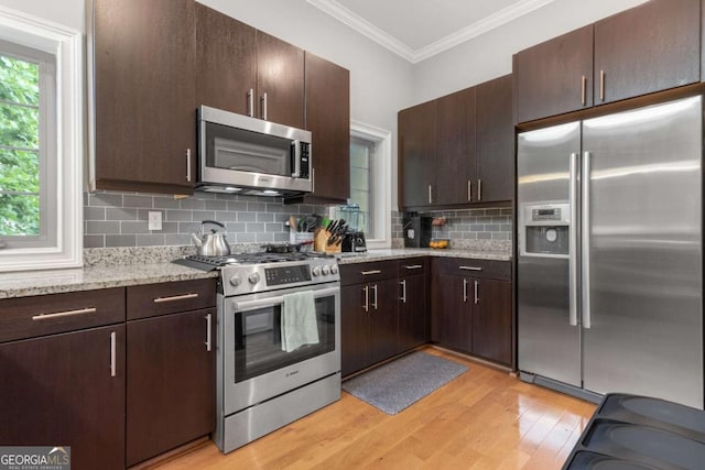 1903 Anjaco Rd NW Unit 5, Atlanta, GA 30309 - kitchen featuring appliances with stainless steel finishes, light wood finished floors, ornamental molding, backsplash, and dark brown cabinets