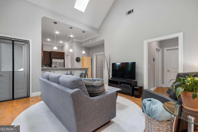 1903 Anjaco Rd NW Unit 5, Atlanta, GA 30309 - living area with high vaulted ceiling, a skylight, and light wood-style flooring
