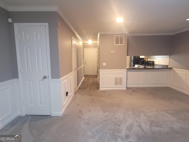 2052 Charter Ln, Lithonia, GA 30058 - unfurnished living room featuring a decorative wall, wainscoting, carpet flooring, ornamental molding, and an office area