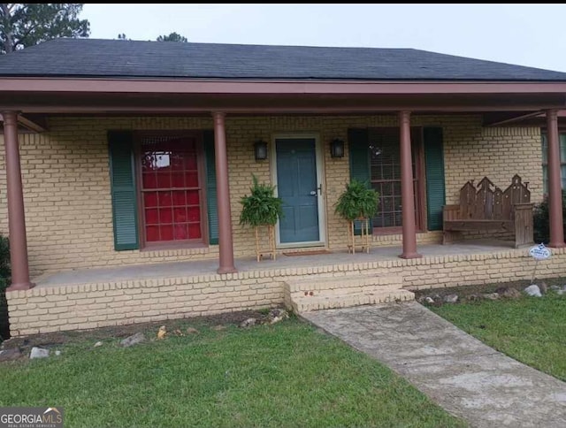 1806 Dawson Rd, Albany, GA 31707 - property entrance with covered porch, brick siding, and roof with shingles