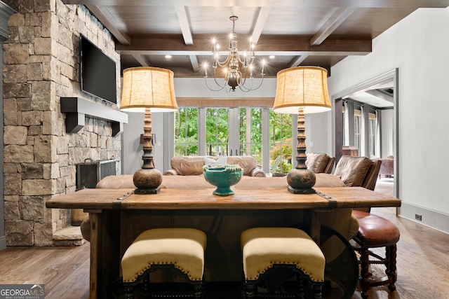4874 Kettle River Pt, Suwanee, GA 30024 - dining space featuring wood finished floors, beam ceiling, and a chandelier
