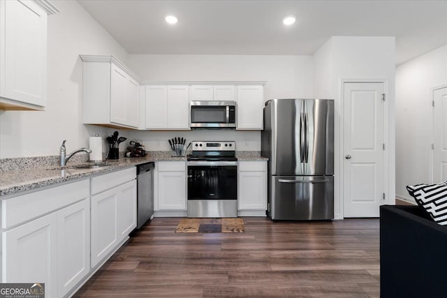 161 Swindon Dr, Mcdonough, GA 30253 - kitchen featuring appliances with stainless steel finishes, white cabinets, recessed lighting, light stone countertops, and dark wood-style flooring