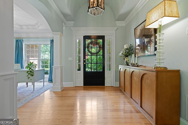 3095 Chattahoochee Trce, Gainesville, GA 30506 - entryway with light wood-style floors, decorative columns, a chandelier, crown molding, and arched walkways