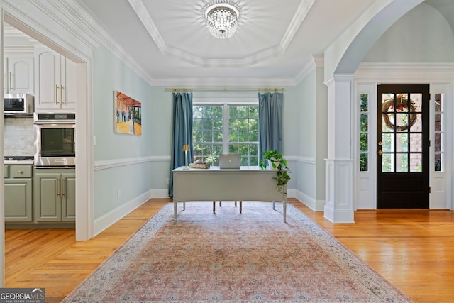 3095 Chattahoochee Trce, Gainesville, GA 30506 - foyer featuring light wood finished floors, decorative columns, a raised ceiling, arched walkways, and a chandelier