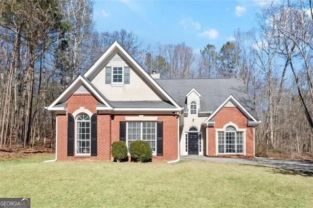 4021 Melvin Dr, Atlanta, GA 30331 - traditional-style home with brick siding, a front lawn, and stucco siding