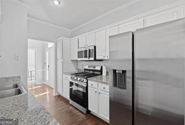 4021 Melvin Dr, Atlanta, GA 30331 - kitchen featuring appliances with stainless steel finishes, ornamental molding, white cabinets, dark wood finished floors, and recessed lighting