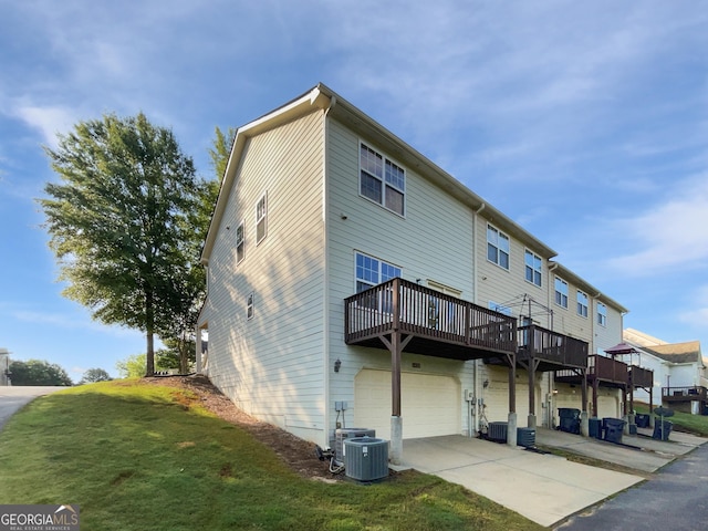 2438 Suwanee Pointe Dr, Lawrenceville, GA 30043 - rear view of house with a deck, a garage, concrete driveway, and a yard