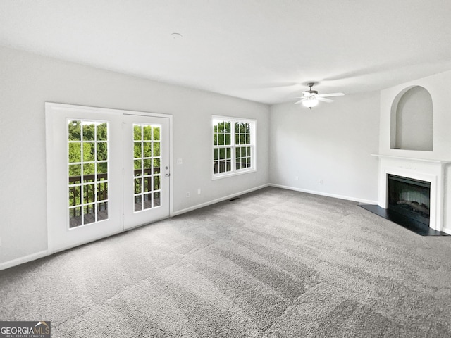 2438 Suwanee Pointe Dr, Lawrenceville, GA 30043 - unfurnished living room with a ceiling fan, carpet flooring, and a fireplace with flush hearth
