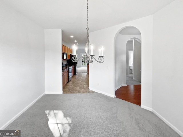 2438 Suwanee Pointe Dr, Lawrenceville, GA 30043 - unfurnished dining area with light colored carpet, arched walkways, a chandelier, and recessed lighting