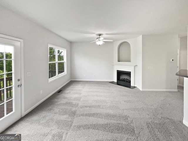 2438 Suwanee Pointe Dr, Lawrenceville, GA 30043 - unfurnished living room with a ceiling fan, a fireplace with flush hearth, and carpet flooring