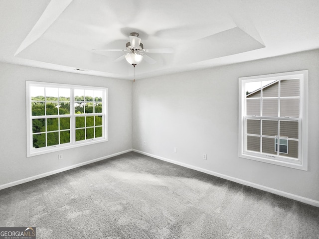 2438 Suwanee Pointe Dr, Lawrenceville, GA 30043 - carpeted spare room featuring a tray ceiling and a ceiling fan