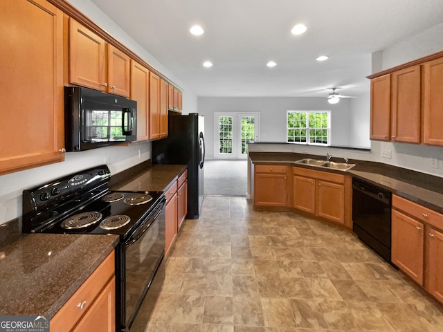 2438 Suwanee Pointe Dr, Lawrenceville, GA 30043 - kitchen with black appliances, recessed lighting, brown cabinets, a peninsula, and a ceiling fan