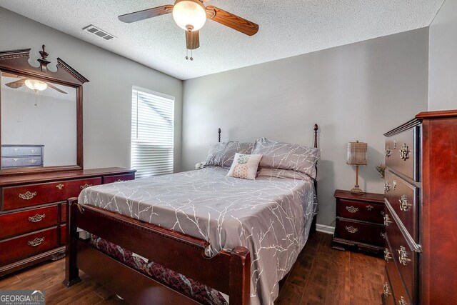 148 Fire Thorn, Pooler, GA 31322 - bedroom featuring dark wood-style flooring, a textured ceiling, and ceiling fan