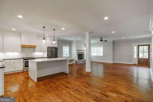 175 Pinecrest Ct, Athens, GA 30605 - kitchen featuring stainless steel stove, refrigerator with ice dispenser, premium range hood, a kitchen island, and open floor plan