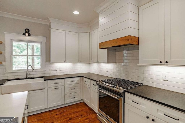 175 Pinecrest Ct, Athens, GA 30605 - kitchen with gas range, crown molding, white cabinets, tasteful backsplash, and dark countertops