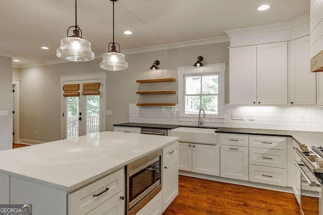 175 Pinecrest Ct, Athens, GA 30605 - kitchen featuring appliances with stainless steel finishes, ornamental molding, healthy amount of natural light, backsplash, and white cabinets