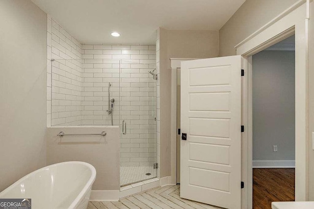 175 Pinecrest Ct, Athens, GA 30605 - bathroom with a stall shower, a freestanding bath, and recessed lighting
