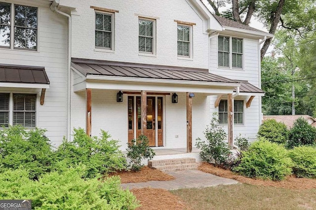 175 Pinecrest Ct, Athens, GA 30605 - view of front of house with a standing seam roof, brick siding, covered porch, and a metal roof