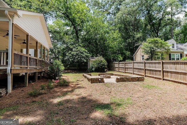 175 Pinecrest Ct, Athens, GA 30605 - fenced backyard with a ceiling fan, a vegetable garden, and a deck