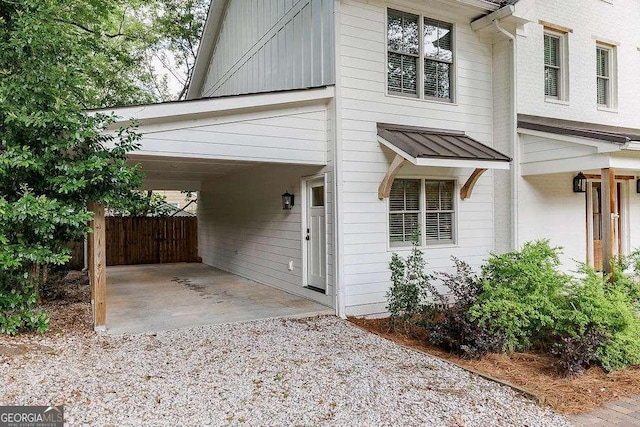 175 Pinecrest Ct, Athens, GA 30605 - view of front of home featuring board and batten siding, gravel driveway, and a carport