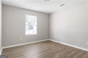 5484 Denny Dr, Atlanta, GA 30349 - empty room featuring dark wood-style floors and baseboards