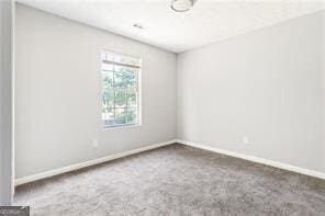 5484 Denny Dr, Atlanta, GA 30349 - carpeted empty room featuring baseboards