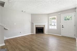 5484 Denny Dr, Atlanta, GA 30349 - unfurnished living room with a fireplace and wood finished floors