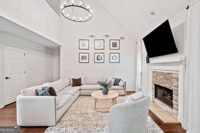 1825 Millstone Ct, Alpharetta, GA 30004 - living area featuring a chandelier, wood finished floors, a stone fireplace, and high vaulted ceiling