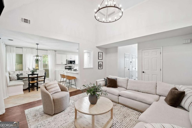 1825 Millstone Ct, Alpharetta, GA 30004 - living area with a chandelier, high vaulted ceiling, and wood finished floors