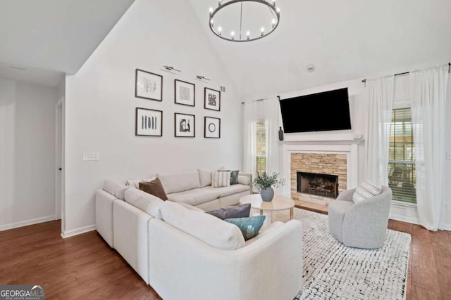 1825 Millstone Ct, Alpharetta, GA 30004 - living room featuring a chandelier, high vaulted ceiling, wood finished floors, and a fireplace